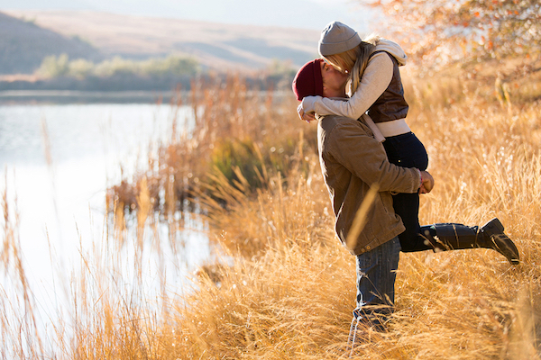 lovely young couple kissing outdoors in autumn