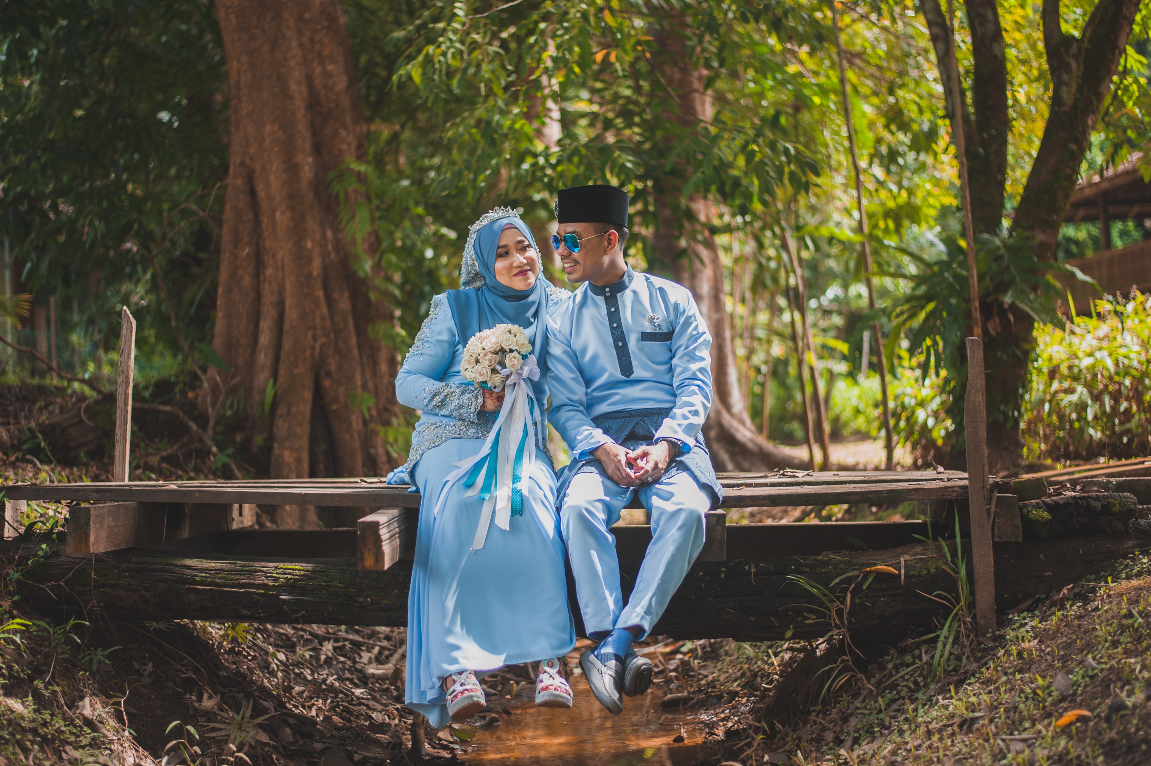 a bride and groom on their wedding day in matching blue colors