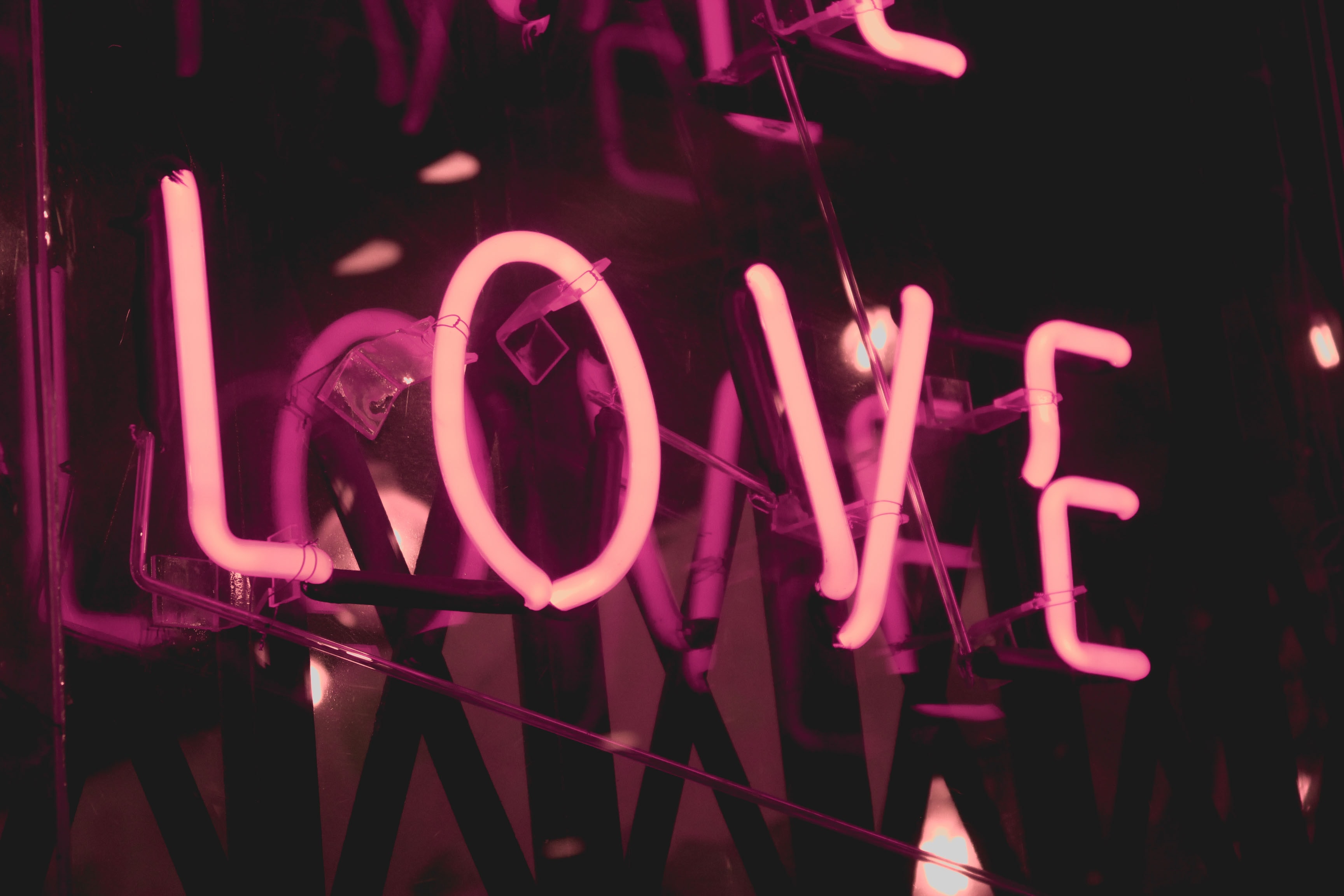 a pink neon sign that says love.